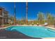 Refreshing community pool area features palm trees, lounge chairs, and a secure safety fence at 12050 N Panorama Dr # 104, Fountain Hills, AZ 85268
