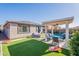 Inviting backyard has a pool, covered patio, and comfortable lounge seating at 12117 W Luxton Ln, Avondale, AZ 85323