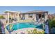 Inviting backyard oasis with a sparkling pool, lounge area, and charming pergola for outdoor relaxation at 12117 W Luxton Ln, Avondale, AZ 85323