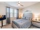 Cozy bedroom features a ceiling fan, gray color palette, and natural light at 12117 W Luxton Ln, Avondale, AZ 85323