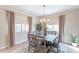 Charming dining area has a rustic table, stylish rug, and natural light at 12117 W Luxton Ln, Avondale, AZ 85323