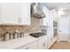 This modern kitchen boasts white cabinets, stainless appliances and a stylish backsplash at 12117 W Luxton Ln, Avondale, AZ 85323