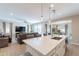 Spacious kitchen island with seating overlooks the living room in this open-concept design at 12117 W Luxton Ln, Avondale, AZ 85323