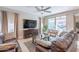 Comfortable living room featuring a plush leather sofa, stylish decor, and sliding doors to outdoor space at 12117 W Luxton Ln, Avondale, AZ 85323