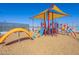 Colorful community playground featuring slides, climbing structures, and a cushioned play surface at 12117 W Luxton Ln, Avondale, AZ 85323