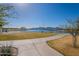 Picturesque community pond with walking path and scenic mountain views in the background at 12117 W Luxton Ln, Avondale, AZ 85323