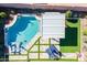 Aerial view of a modern pool with an extended patio, lounge chairs, and artificial turf at 12117 W Luxton Ln, Avondale, AZ 85323