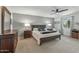 Comfortable bedroom with ceiling fan, two side tables, and a large window at 12822 W Ballad Dr, Sun City West, AZ 85375