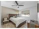 Well-lit bedroom featuring a ceiling fan and large bed at 12822 W Ballad Dr, Sun City West, AZ 85375
