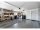 Well-lit garage featuring storage shelves and organized space at 12822 W Ballad Dr, Sun City West, AZ 85375