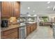 Spacious kitchen featuring granite countertops, stainless steel appliances, and a view into the adjacent living area at 12822 W Ballad Dr, Sun City West, AZ 85375