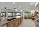 Bright kitchen with granite countertops and a breakfast bar overlooking the living area at 12822 W Ballad Dr, Sun City West, AZ 85375