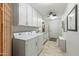 Bright laundry room with white cabinetry and appliances at 12822 W Ballad Dr, Sun City West, AZ 85375