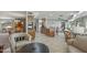 Open-concept living area flowing into the kitchen with tile flooring, neutral decor, and comfortable seating at 12822 W Ballad Dr, Sun City West, AZ 85375
