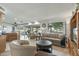 Inviting living room featuring large windows with views of the golf course at 12822 W Ballad Dr, Sun City West, AZ 85375