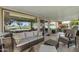Inviting covered patio featuring comfortable seating and views of the lush green landscape at 12822 W Ballad Dr, Sun City West, AZ 85375