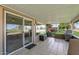 Covered patio with tile flooring and sliding glass doors offer seamless indoor-outdoor living at 12822 W Ballad Dr, Sun City West, AZ 85375