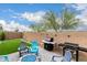 Spacious backyard features a grill, artificial turf, and seating around a fire pit at 14254 W Honeysuckle Dr, Surprise, AZ 85387