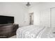 Bright bedroom with white walls, large dresser, and sliding closet doors with a ceiling fan at 14254 W Honeysuckle Dr, Surprise, AZ 85387