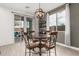 Cozy dining area features a stylish chandelier and a seamless transition to the outdoor patio at 14254 W Honeysuckle Dr, Surprise, AZ 85387
