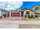 Charming single-story home featuring a brick driveway, two-car garage, and well-maintained landscaping at 14254 W Honeysuckle Dr, Surprise, AZ 85387