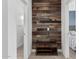 A hallway with decorative wood wall and storage bench between rooms with modern interiors at 14254 W Honeysuckle Dr, Surprise, AZ 85387