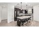 Modern kitchen boasts granite counters, an island with seating, and stainless steel appliances at 14254 W Honeysuckle Dr, Surprise, AZ 85387