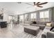 Spacious living room with neutral tones, large windows and comfortable seating arrangement at 14254 W Honeysuckle Dr, Surprise, AZ 85387