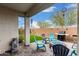 Inviting covered patio with outdoor kitchen, water feature and fire pit at 14254 W Honeysuckle Dr, Surprise, AZ 85387