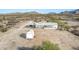 Desert home showcasing mountain views, a covered parking area, and an outdoor storage building at 15001 W Camdon Dr, Casa Grande, AZ 85194