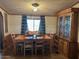 Bright dining room featuring a wooden table and chairs, complemented by a charming china cabinet at 15001 W Camdon Dr, Casa Grande, AZ 85194