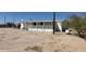 Ranch home exterior with a front porch, propane tank, and desert landscape at 15001 W Camdon Dr, Casa Grande, AZ 85194