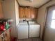 Practical laundry room with washer, dryer, and overhead storage cabinets at 15001 W Camdon Dr, Casa Grande, AZ 85194
