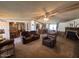 Comfortable living room with a ceiling fan, a fireplace, and cozy leather furniture at 15001 W Camdon Dr, Casa Grande, AZ 85194