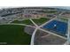 Aerial view of community green space with a playground, picnic area and basketball court at 15660 W Deanne Dr, Waddell, AZ 85355