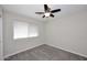 Bedroom features neutral carpeting, ceiling fan, and a window at 1966 E Pebble Beach Dr, Tempe, AZ 85282
