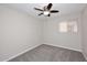 Bedroom features neutral carpeting, ceiling fan, and a window at 1966 E Pebble Beach Dr, Tempe, AZ 85282