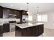 Lovely kitchen with granite countertops, stainless steel appliances, tiled flooring and island sink with cabinet storage at 1966 E Pebble Beach Dr, Tempe, AZ 85282