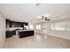 Bright kitchen with stainless appliances, island, pendant lighting and dark cabinets, tiled floors and neutral walls at 1966 E Pebble Beach Dr, Tempe, AZ 85282