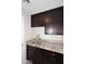 This laundry room features a stainless steel sink, granite countertops, and dark cabinets at 1966 E Pebble Beach Dr, Tempe, AZ 85282