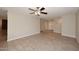 Spacious living room with tile floors and a ceiling fan, providing a blank canvas for personalization at 1966 E Pebble Beach Dr, Tempe, AZ 85282