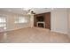 Spacious living room with brick fireplace, decorative wall, tiled floors, ceiling fan and sliding door to backyard at 1966 E Pebble Beach Dr, Tempe, AZ 85282