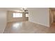 Well-lit living room with large windows and neutral tile flooring, perfect for relaxation at 1966 E Pebble Beach Dr, Tempe, AZ 85282