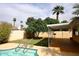 The home features a sparkling pool surrounded by lush trees and landscaping at 1966 E Pebble Beach Dr, Tempe, AZ 85282