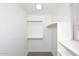 Neutral carpeting and built-in shelving in the walk-in closet at 1966 E Pebble Beach Dr, Tempe, AZ 85282