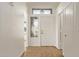 Bright foyer with wood look tile flooring, neutral paint and transom window for added natural light at 19801 N 6Th Pl, Phoenix, AZ 85024