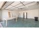 An oversized garage with a table and chairs, a fridge, and a water heater at 19801 N 6Th Pl, Phoenix, AZ 85024