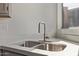 Close up of the stainless steel kitchen sink with bright window at 19801 N 6Th Pl, Phoenix, AZ 85024