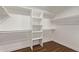 Spacious walk-in closet with ample shelving and wood floor at 19801 N 6Th Pl, Phoenix, AZ 85024