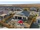 Aerial view of a fenced in backyard oasis with a patio, seating, desert landscaping, and a covered patio at 20331 N Wagner Wash Dr, Buckeye, AZ 85396